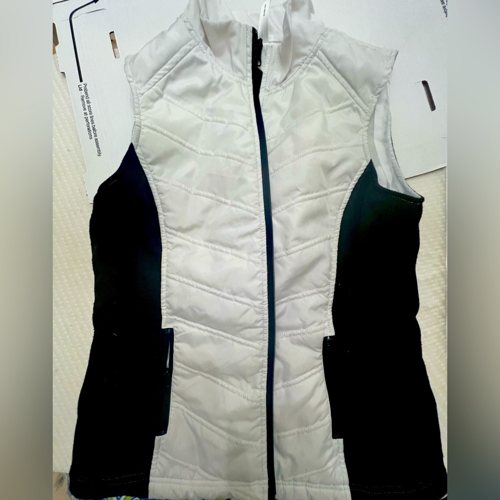 Exerted black and white vest.